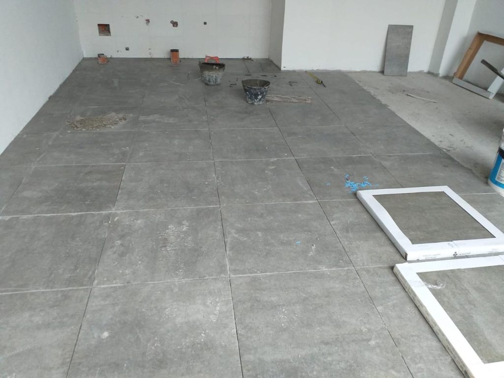Colocación de piso interior cerámico en espacio amplio