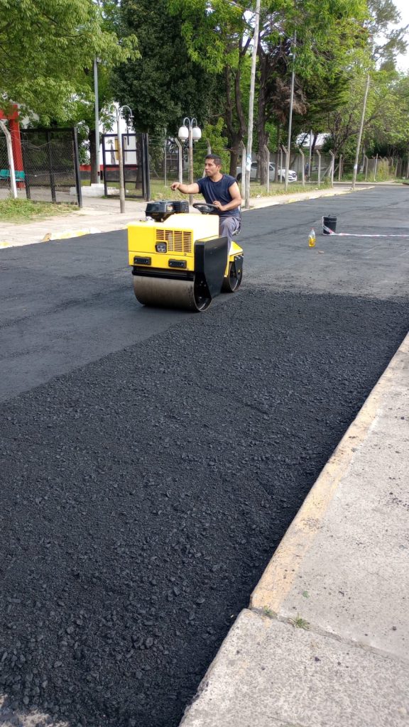 Maquinaria compactando pavimento nuevo en vía urbana